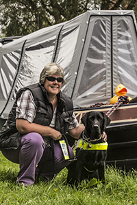 Guide Dog Oakley with "Mum" Tracey Clarke alongside their home "nb Sola Gratia"